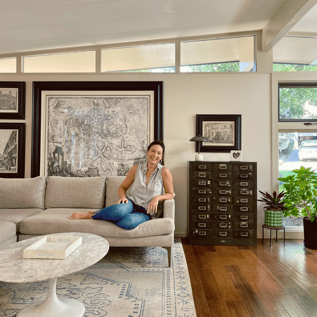 Libby Bryant, creative business coach sitting on sofa